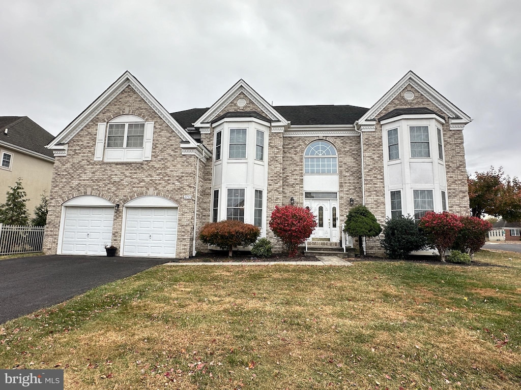 view of front of property with a garage and a front yard