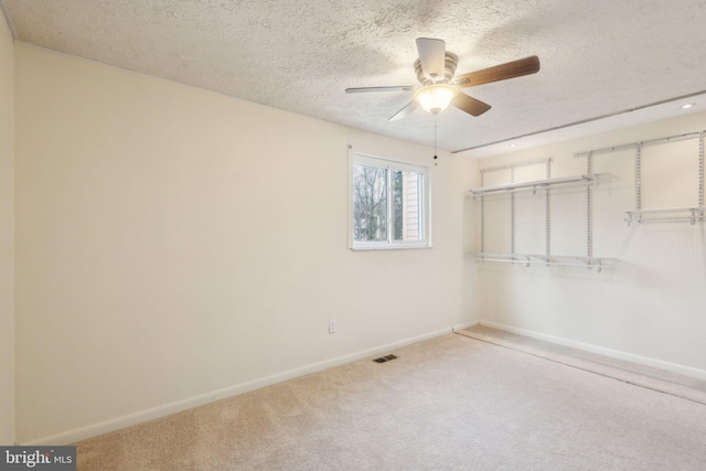 unfurnished bedroom featuring carpet flooring, ceiling fan, a closet, and a textured ceiling