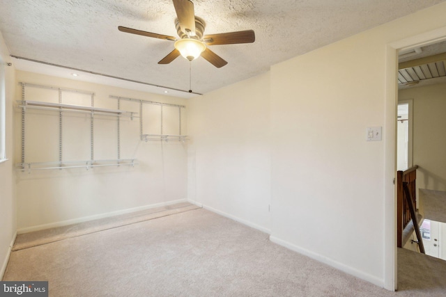 interior space with ceiling fan, a closet, and a textured ceiling