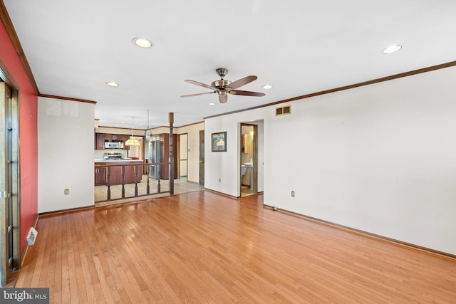 unfurnished living room with ornamental molding, light hardwood / wood-style floors, and ceiling fan