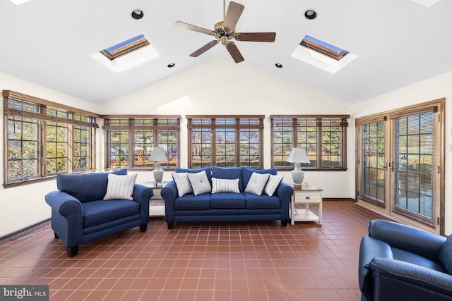 sunroom / solarium featuring lofted ceiling with skylight and ceiling fan