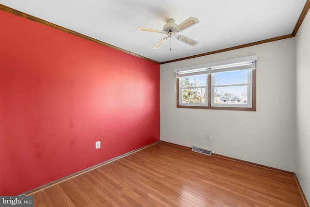 spare room with crown molding, light hardwood / wood-style flooring, and ceiling fan