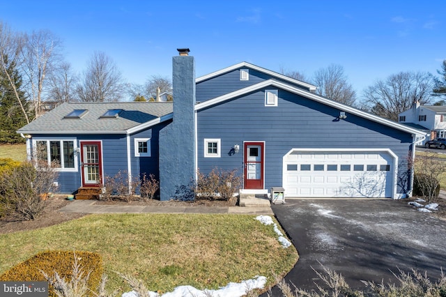 view of front facade with a garage and a front lawn