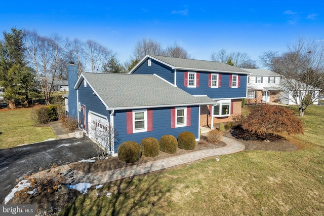 view of front of house featuring a garage and a front yard