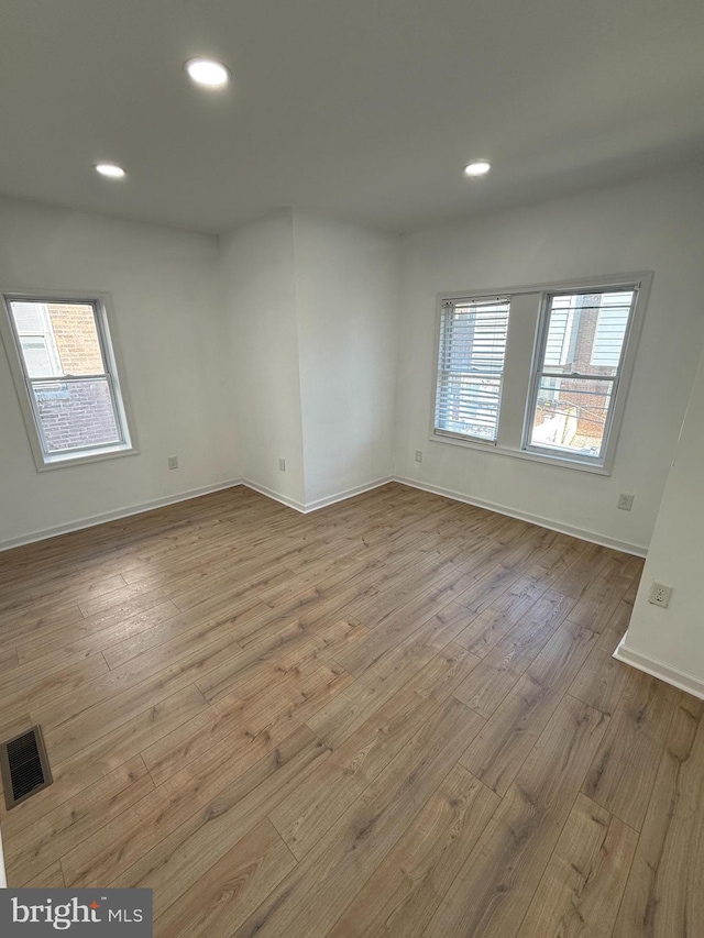 unfurnished room with light wood-type flooring