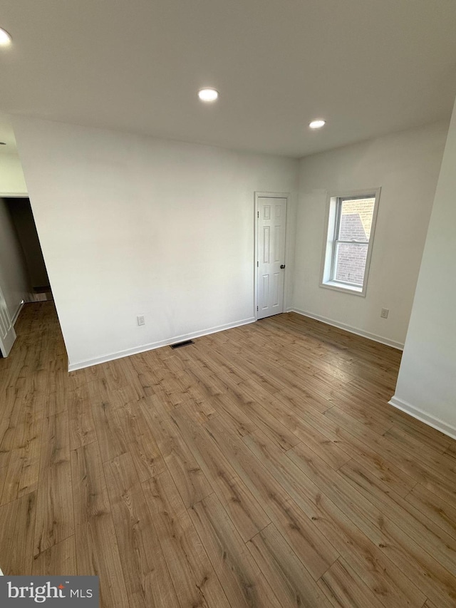 spare room featuring light hardwood / wood-style floors