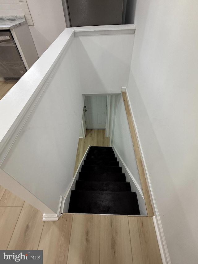 stairs with hardwood / wood-style flooring