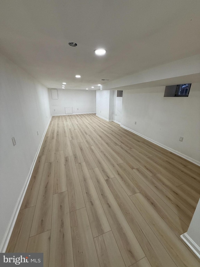 basement with light hardwood / wood-style floors