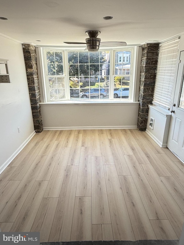 unfurnished dining area with ceiling fan and light hardwood / wood-style floors