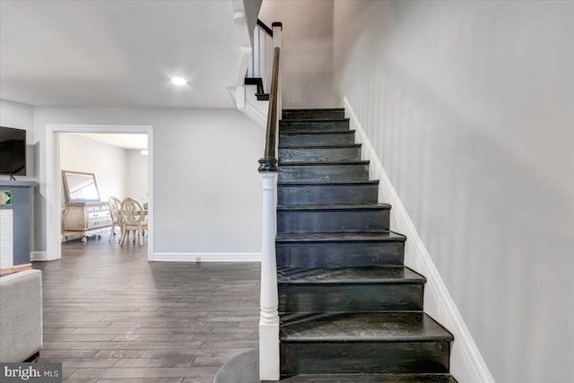 stairway featuring wood-type flooring