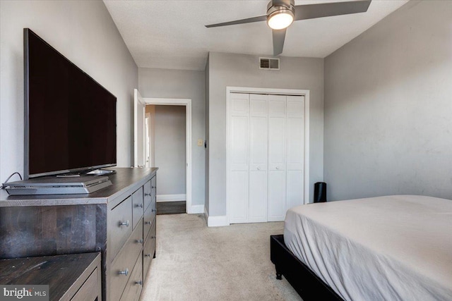 carpeted bedroom with a closet and ceiling fan