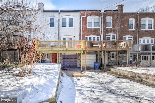 view of front facade with a wooden deck and a garage