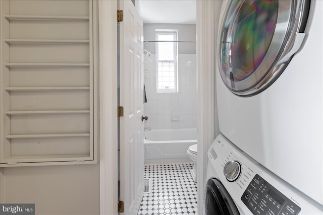 laundry room with stacked washer and dryer