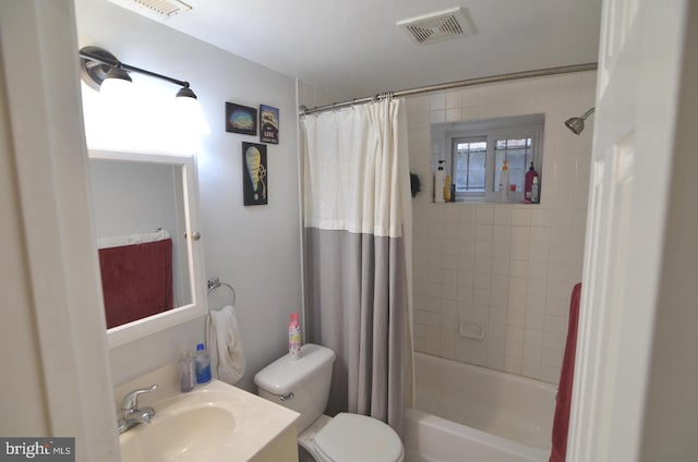 full bathroom with vanity, shower / bath combo with shower curtain, and toilet