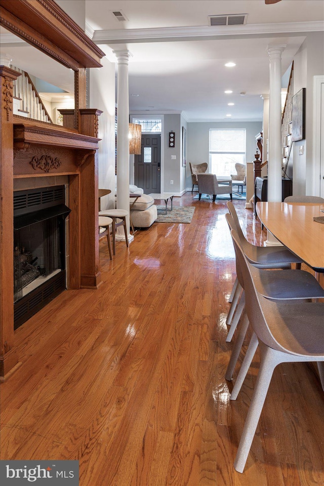 dining room with crown molding and hardwood / wood-style flooring