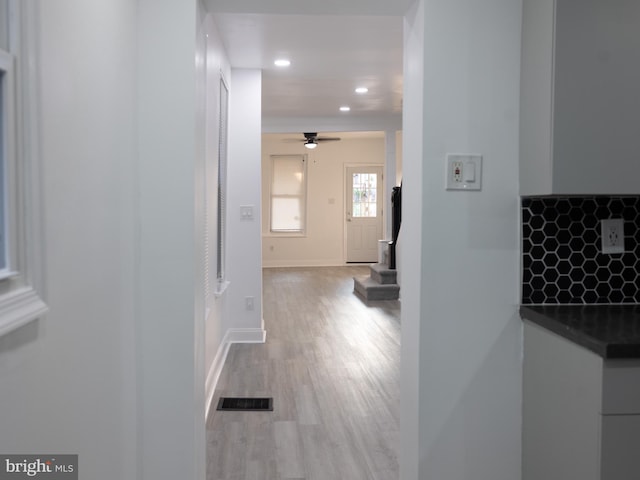 corridor with light hardwood / wood-style flooring