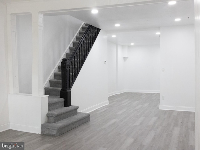 stairs featuring hardwood / wood-style floors