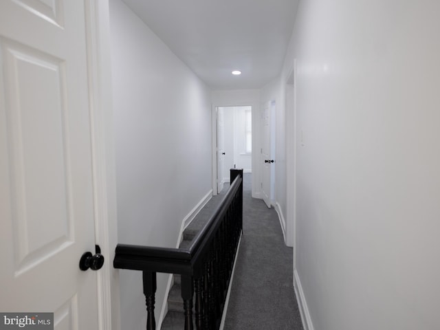 corridor with dark colored carpet