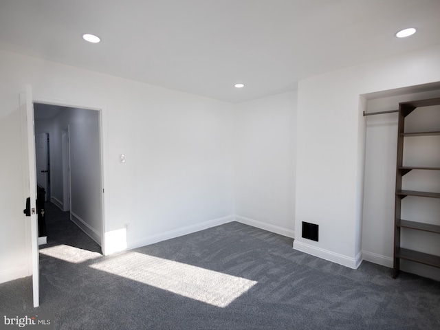 unfurnished bedroom featuring dark carpet