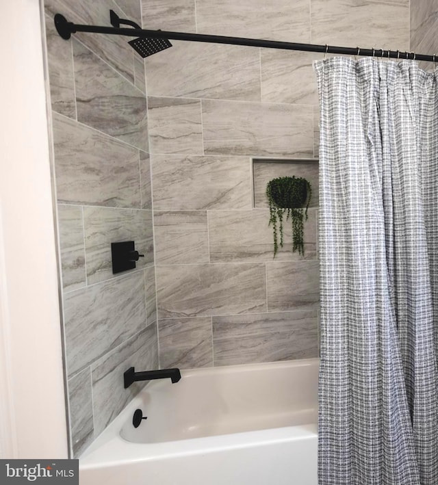 bathroom with shower / bath combo with shower curtain