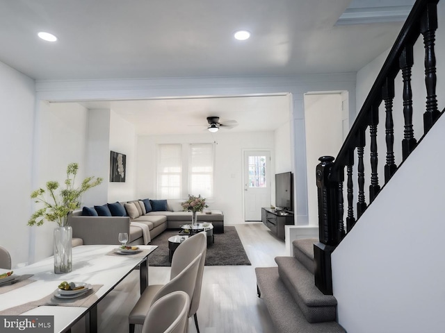 living room featuring ceiling fan and light hardwood / wood-style floors