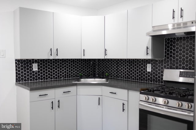 kitchen featuring white cabinets, decorative backsplash, gas stove, and sink