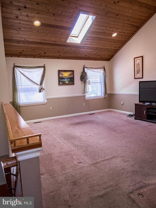 unfurnished room featuring carpet, recessed lighting, lofted ceiling with skylight, wooden ceiling, and baseboards