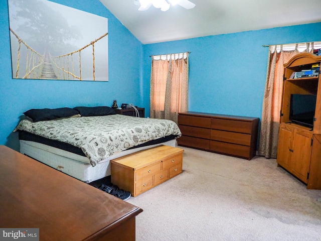 bedroom featuring vaulted ceiling, a ceiling fan, and light colored carpet