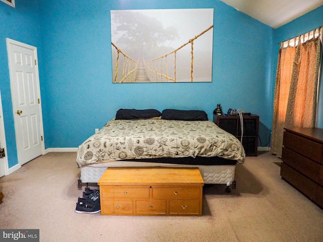 carpeted bedroom with vaulted ceiling and baseboards