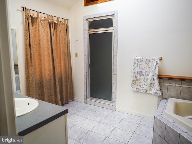 full bath featuring a garden tub, tile patterned flooring, vanity, and baseboards