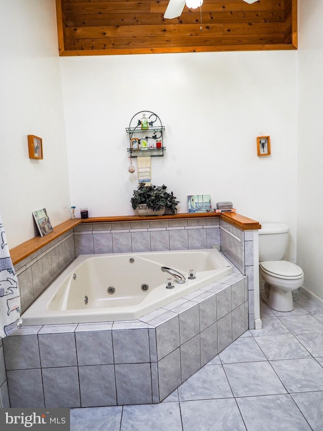 full bathroom with a whirlpool tub, ceiling fan, toilet, and tile patterned floors