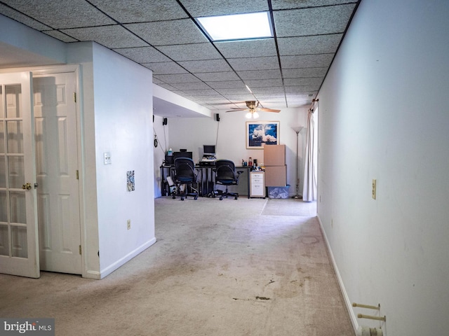 office featuring carpet floors, a ceiling fan, a paneled ceiling, and baseboards