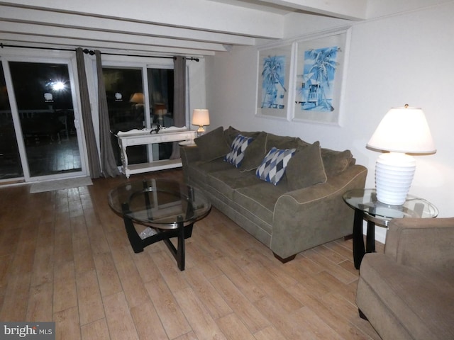 living room with light wood-type flooring and beam ceiling