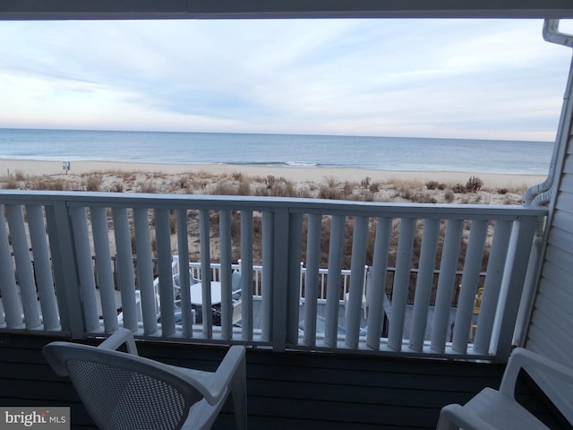 balcony featuring a water view and a view of the beach