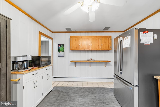 kitchen with white cabinets, stainless steel fridge, and ornamental molding