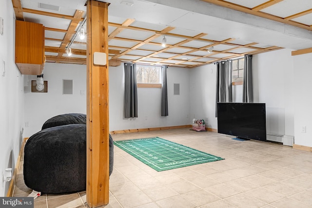 basement featuring a baseboard heating unit and light tile patterned floors