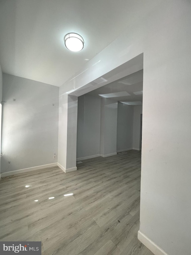 basement with light hardwood / wood-style floors