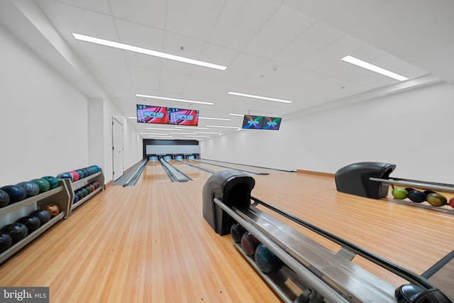 playroom with bowling, a drop ceiling, and wood finished floors