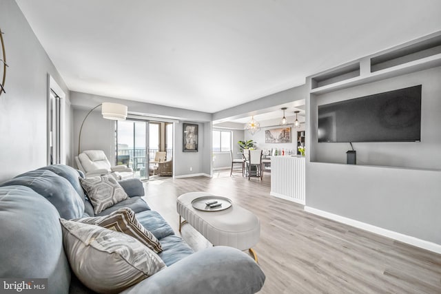 living room with baseboards and wood finished floors