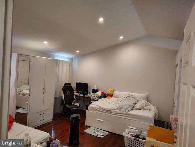 bedroom featuring vaulted ceiling, wood finished floors, and recessed lighting