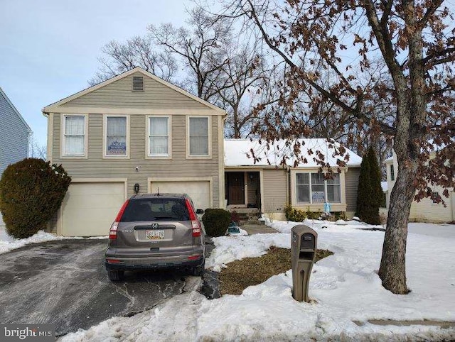 view of front of property with an attached garage and aphalt driveway