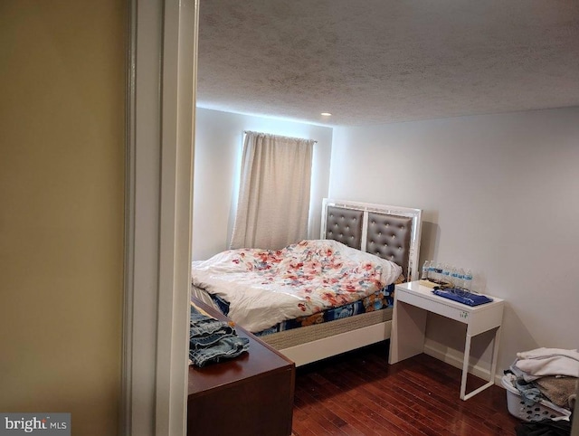 bedroom featuring a textured ceiling and hardwood / wood-style floors