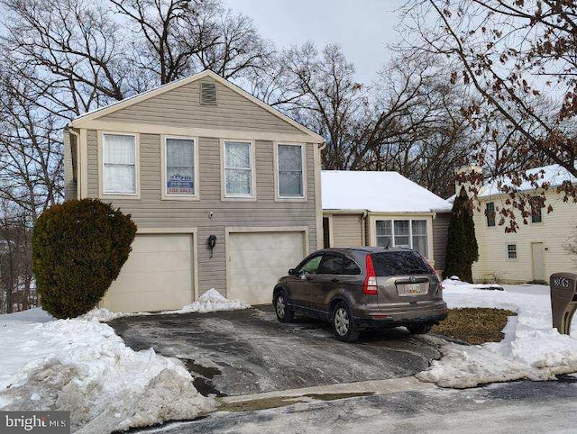 exterior space with a garage and aphalt driveway