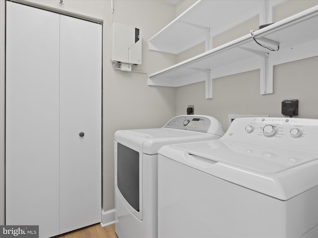 washroom featuring independent washer and dryer and light wood-type flooring