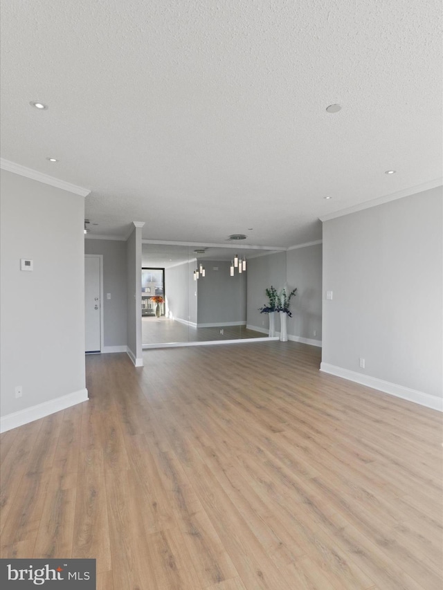 unfurnished living room with a textured ceiling, light hardwood / wood-style flooring, and crown molding