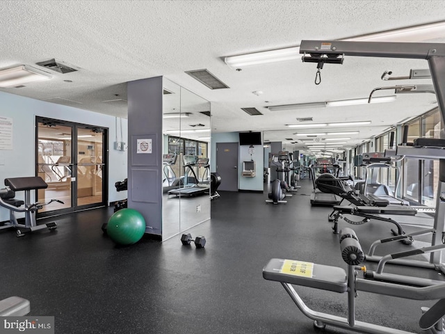 gym featuring a textured ceiling