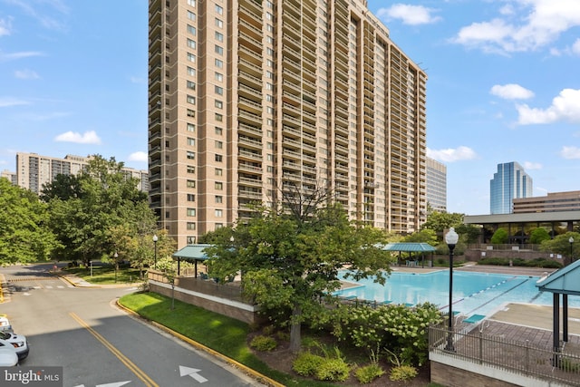 view of building exterior featuring a community pool