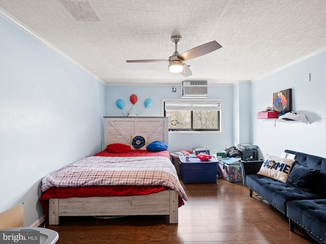 bedroom with ceiling fan, dark hardwood / wood-style flooring, a wall mounted AC, crown molding, and a textured ceiling