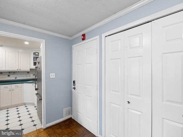 interior space with a textured ceiling and ornamental molding