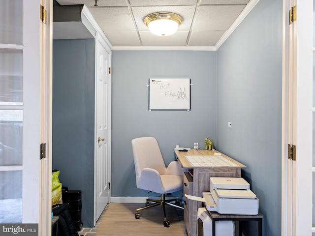 office area featuring a paneled ceiling, light hardwood / wood-style floors, and crown molding